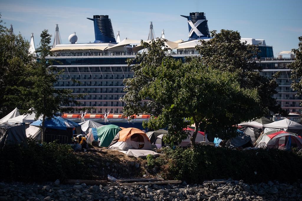 B.C. Human Rights Tribunal will hear a complaint from those who camp at Crab Park and allege the City of Vancouver and its park board discriminate against them by not providing "basic Tents and people are seen at a homeless encampment at Crab Park as the Celebrity Cruises vessel Celebrity Eclipse is docked at port in Vancouver, B.C., Sunday, Aug. 14, 2022. 