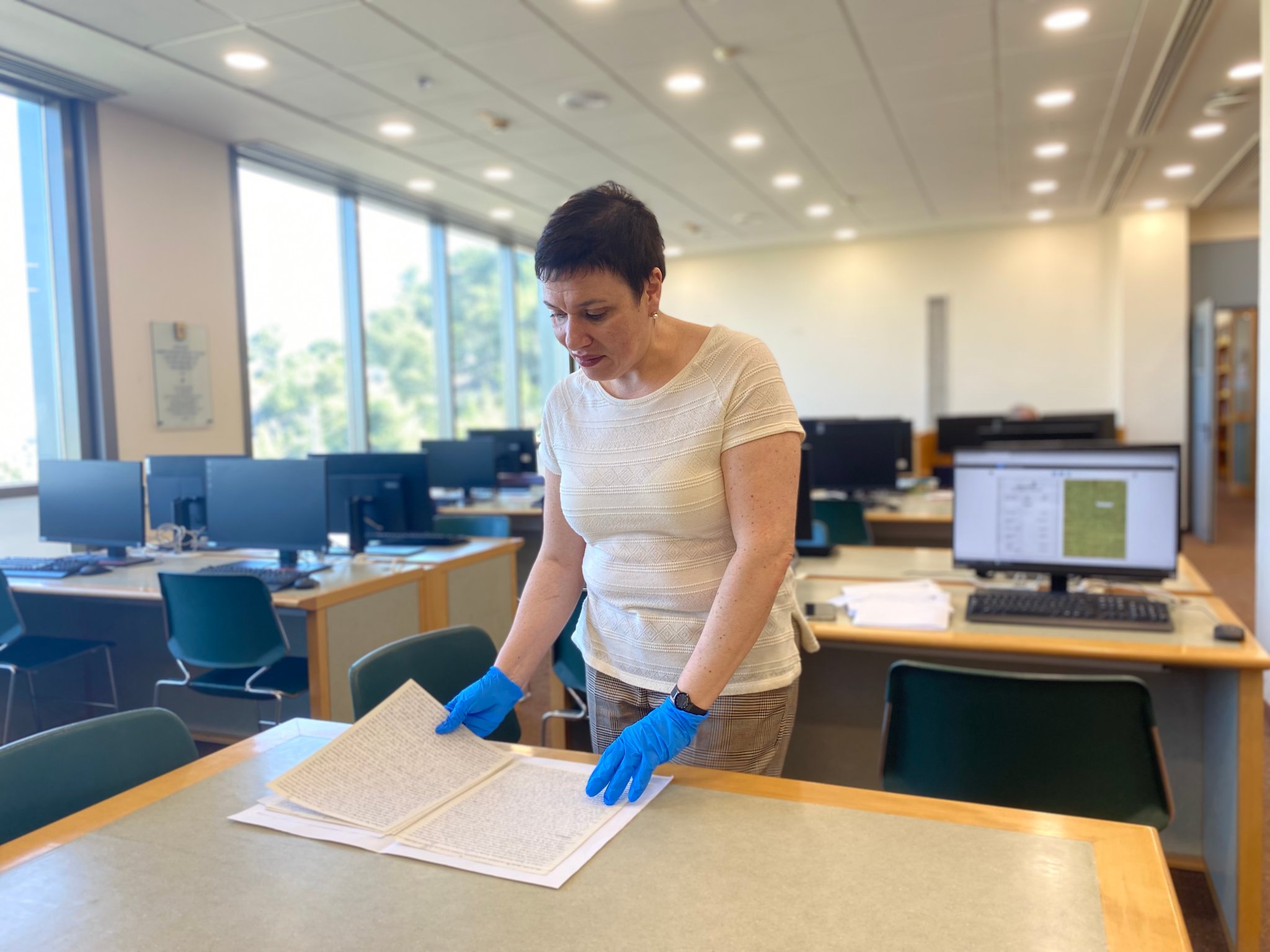 At the Yad Vashem Holocaust archives in Israel, researcher Sima Velkovich examines the written testimony of survivor Dine-Zise Flom.
